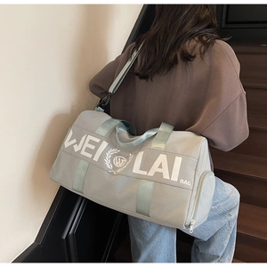 Close-up of gray fitness bag with mint green straps and WEI LAI BAG printed logo