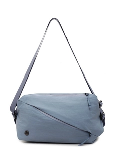 Blue-grey canvas crossbody pillow bag with unique diagonal zipper and metallic logo