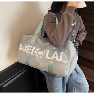 Light gray fitness bag with WEI LAI logo shown on a model's shoulder in a lifestyle setting