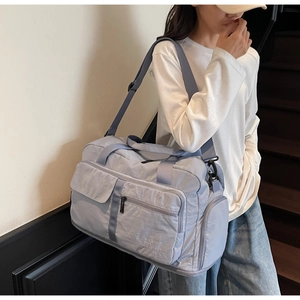Close-up of lightweight nylon travel bag showing waterproof texture and side pockets