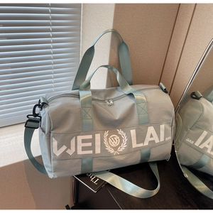 Detail showing high-capacity blue fitness bag with adjustable strap and WEI LAI logo