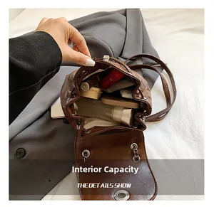 Detail view of brown quilted backpack interior showing space for phone and cosmetics
