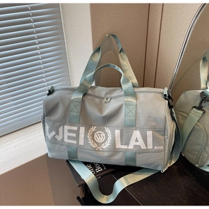 Detail view of the durable grey-green fitness travel bag with reinforced webbing handles