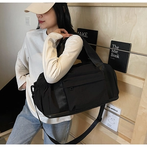Detail of black large capacity travel bag with wide straps and adjustable shoulder strap