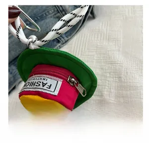 Detail of hat-shaped mini pouch with smooth zipper and colorful patchwork nylon fabric