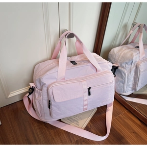 Detail of light pink large capacity travel bag with water-resistant nylon fabric