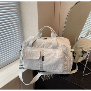 Detail of light beige travel bag with wet-dry pockets and durable nylon texture
