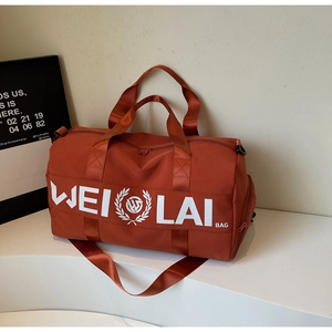 Macro detail of red sports bag with durable fabric, sturdy handles and woven logo