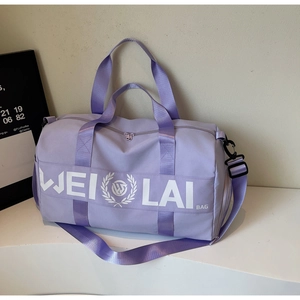 Detail of light purple nylon fitness bag showing the white logo and adjustable shoulder strap