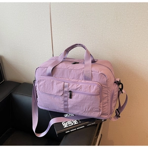 Detail view of large capacity lavender travel bag with waterproof nylon and shoulder strap