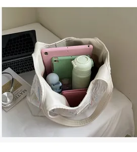 Top view of white quilted tote bag showing large capacity with daily essentials inside