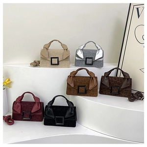 Detail view of mini leopard print suede bags with knot handles and square buckles
