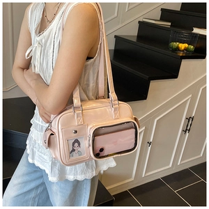Detail of pink patent leather shoulder bag with transparent front slot for mobile phone