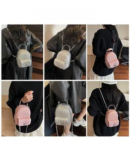 Detail shots of mini quilted backpacks in silver and pink with metallic chain straps