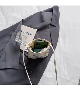 Interior view showing the large capacity for a smartphone and lipstick in a floral bag