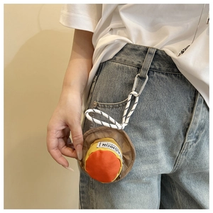 Close-up of a mini hat-shaped earphone pouch clipped to a blue denim belt loop