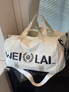 Cream white gym bag with black logo featuring water resistant fabric and adjustable strap
