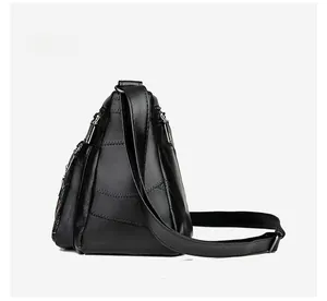 Side view of black quilted leather shoulder bag with multi-layer zipper compartments