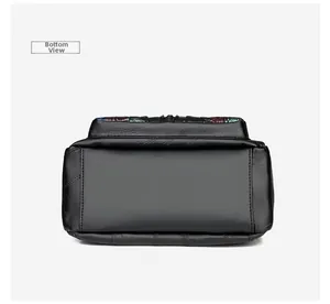 Bottom view of black faux leather bag showing stitching details and floral embroidery