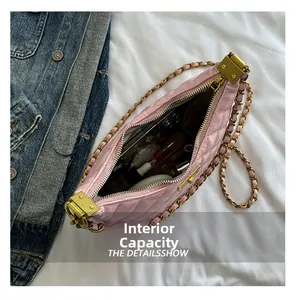 Internal capacity of pink quilted chain bag showing space for phone and makeup items