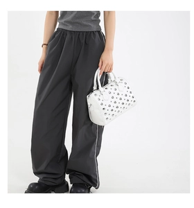 Detail of white Boston handbag with silver metal studs and trendy rivet patterns