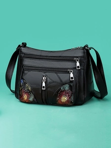 Elegant black leather shoulder bag with floral embroidery and multiple zip pockets