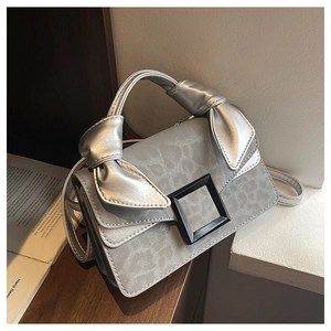 Detail of silver leopard print mini bag with knotted bow handle and matte black buckle