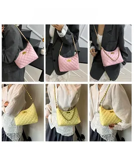 Detail view of quilted leather crossbody bags in pink and yellow with gold chain straps