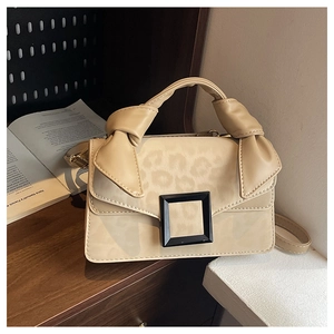 Close-up of cream PU handbag featuring leopard print flap and square buckle detail