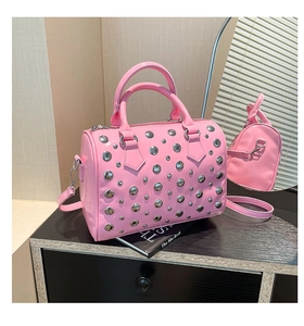 Detail of pink studded boston bag with silver rivets and metal hooks on leather