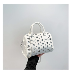 Detail of white Boston bag with silver studs and adjustable shoulder strap
