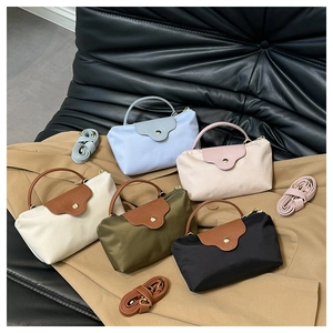 Detailed display of mini nylon dumpling bags in five colors with leather flaps and straps