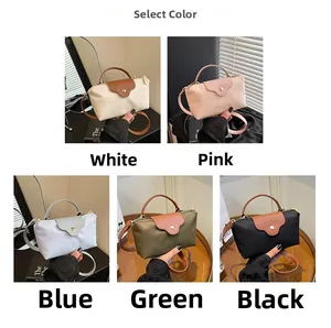 Detail view of nylon crossbody bags in five colors including white, pink and green
