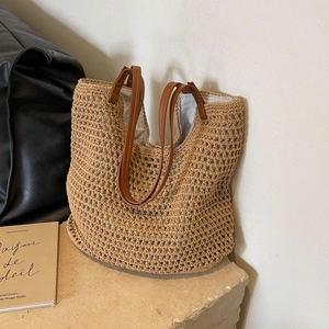 Macro detail of hand-woven tote bag texture with brown leather handles and inner lining