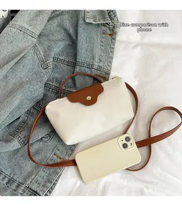 Mini nylon dumpling bag in white and brown with a phone shown for scale comparison