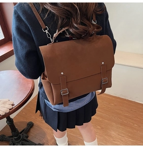 Detail view of brown vintage backpack with leather texture and buckle straps