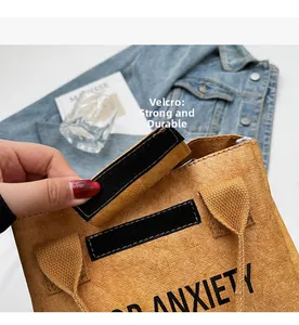 Detail of the brown Tyvek waterproof bag showing a Velcro closure for quick access