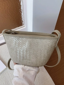 Minimalist woven bucket bag for women featuring premium leather and a slim shoulder strap
