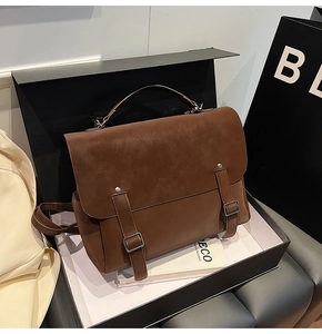 Detail of vintage brown leather backpack with silver buckles in luxury packaging