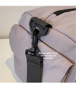 Detail of detachable swivel hook and durable nylon strap on purple travel bag