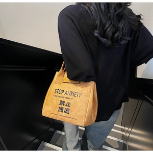 Detail of waterproof Dupont paper tote bag featuring bold Stop Anxiety printed slogan