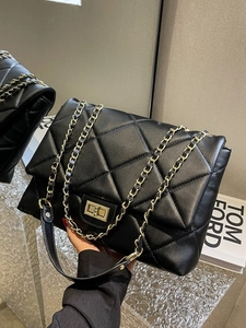 Elegant black quilted leather handbag with gold chain strap and twist-lock closure