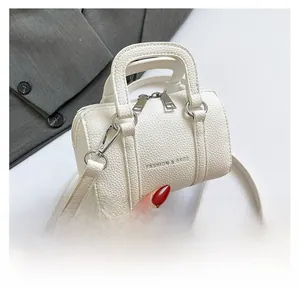 Close-up of white lychee texture mini Boston bag with dual metal zippers and brand logo