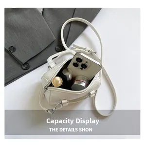 Interior view of mini white Boston bag showing capacity for phone and skincare products