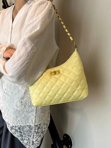 Stylish light yellow quilted shoulder bag with gold chain strap and turn-lock closure