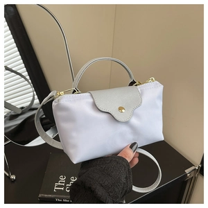 Detail of lavender nylon mini bag with leather flap and gold snap button closure