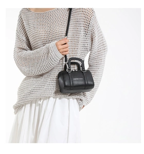Close-up of black lychee grain mini pillow bag with white text and silver hardware