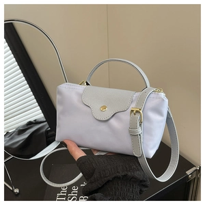 Detail of light purple nylon dumpling bag with grey leather flap and golden hardware