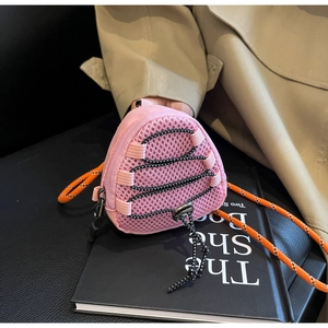 Close-up of pink mesh mini wallet with orange rope strap and black bungee cords