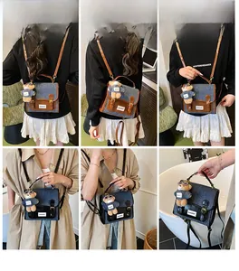Detailed views of a vintage denim backpack with brown straps and a plush bear charm